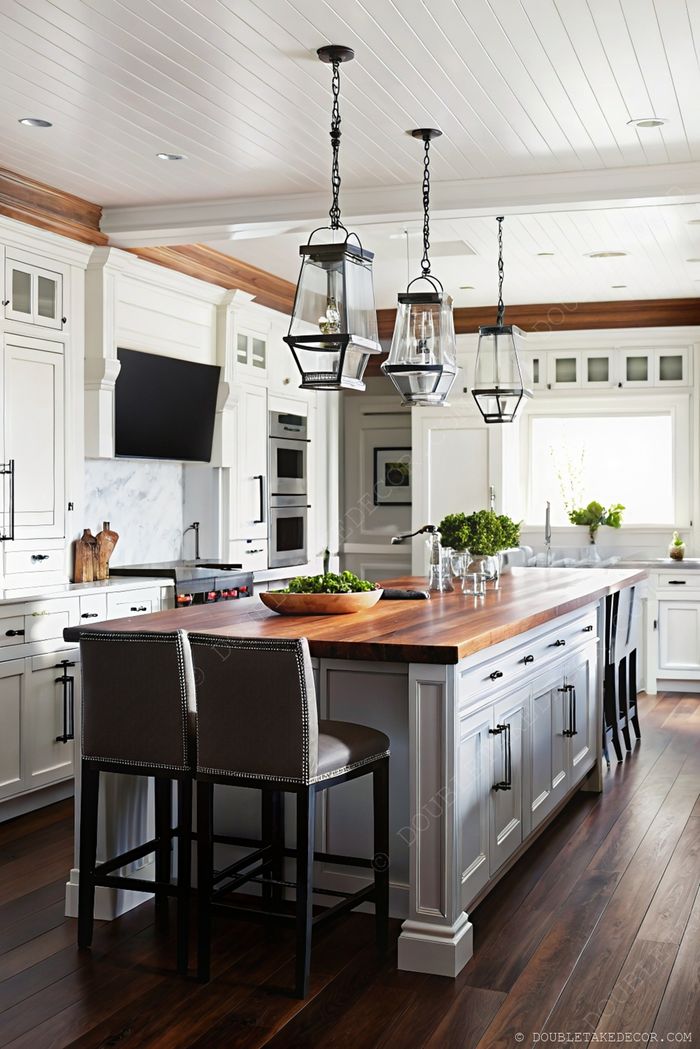 Modern kitchen with white cabinetry and dark wood countertop featuring pendant lights, marble backsplash and stylish bar stools.