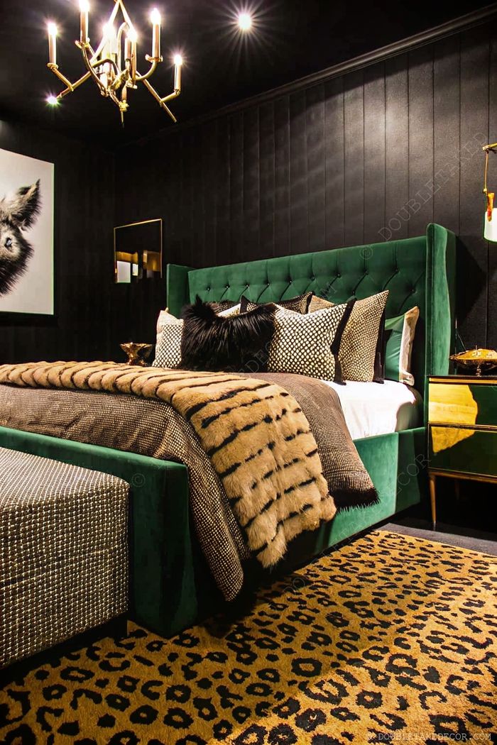 Modern bedroom with black textured walls, green velvet headboard, and gold accents creating a sophisticated earth-tone sanctuary.