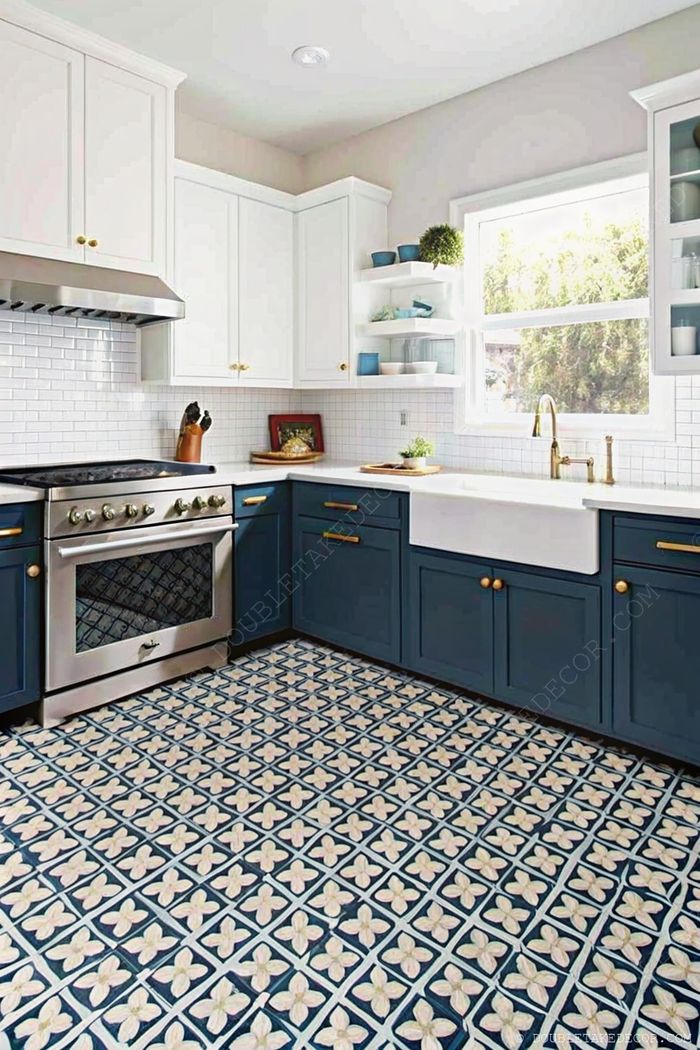Elegant kitchen with white upper and navy blue lower cabinets, farmhouse sink, patterned floor tiles, and subway tile backsplash.